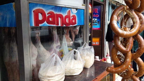 Some pandas hanging in the window
