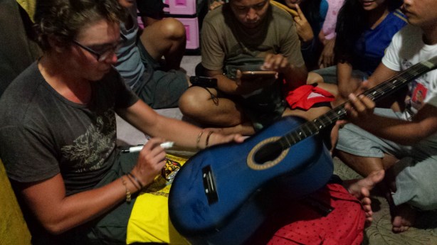Signing the guitar with the family